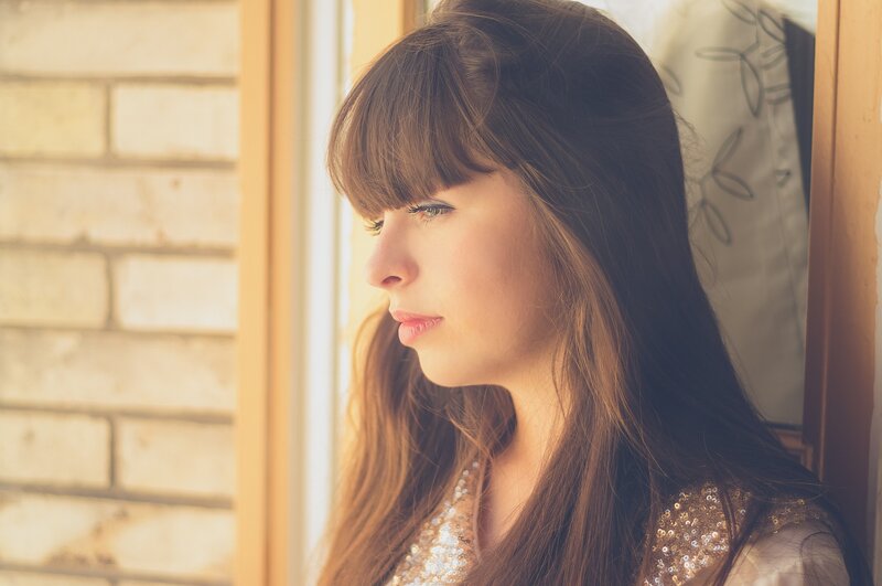 woman looking out window