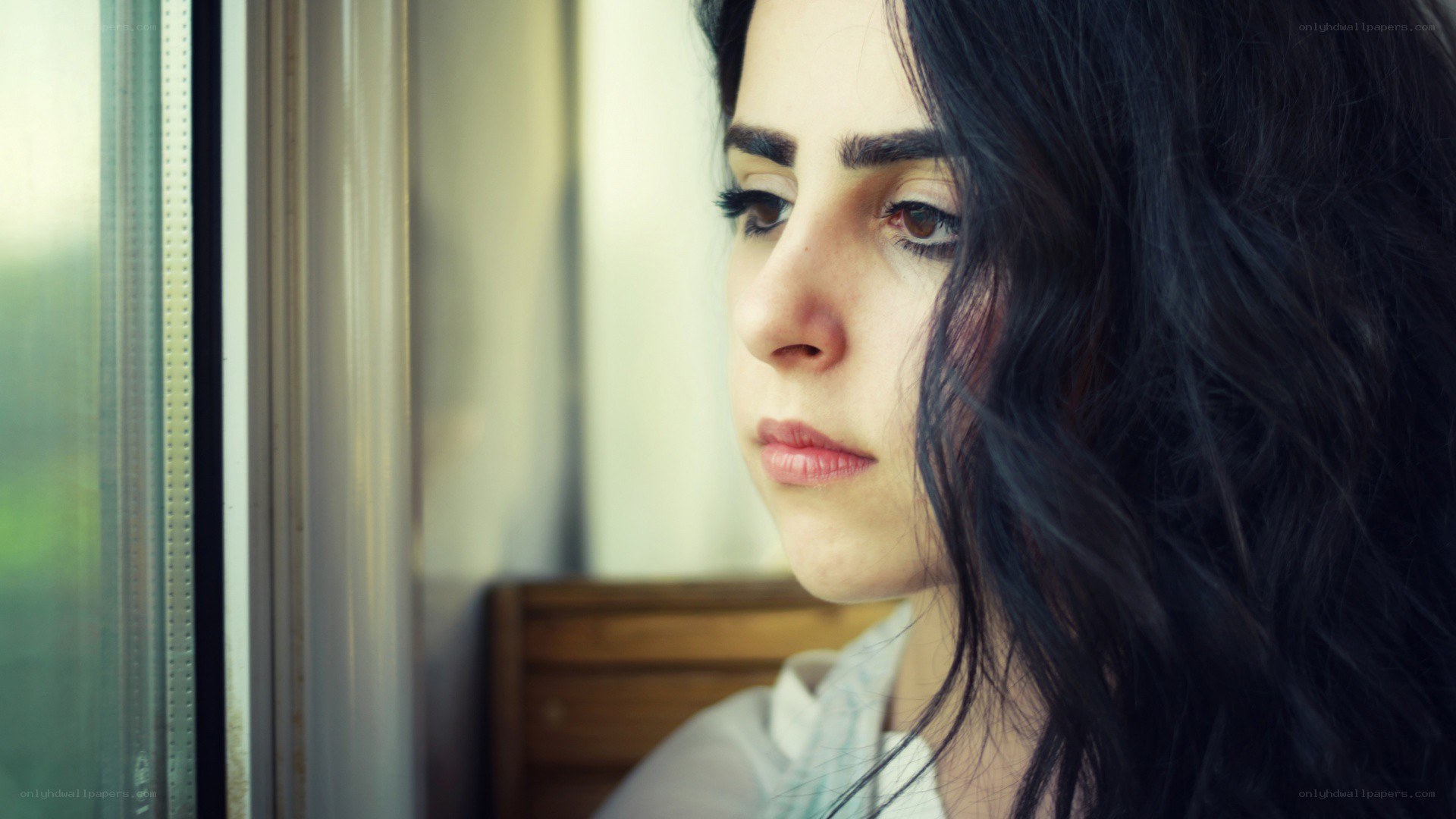 woman looking out window