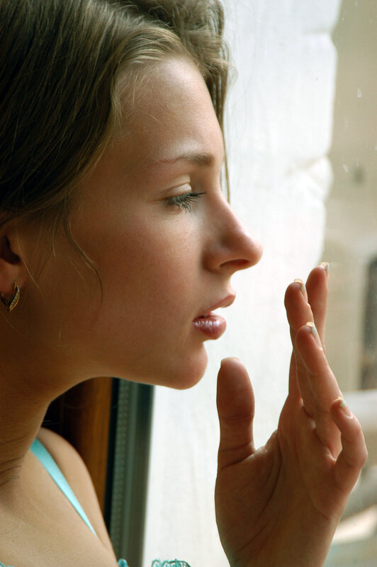 woman looking out window