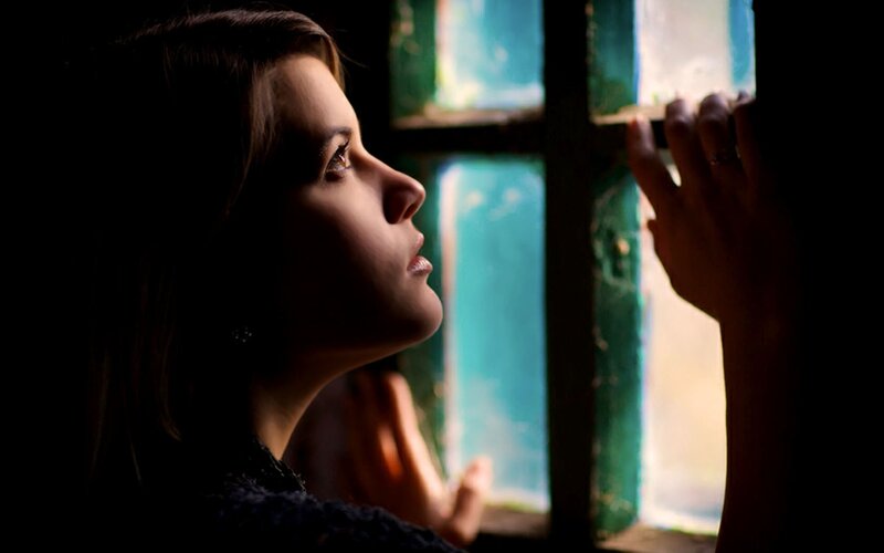 woman looking out window