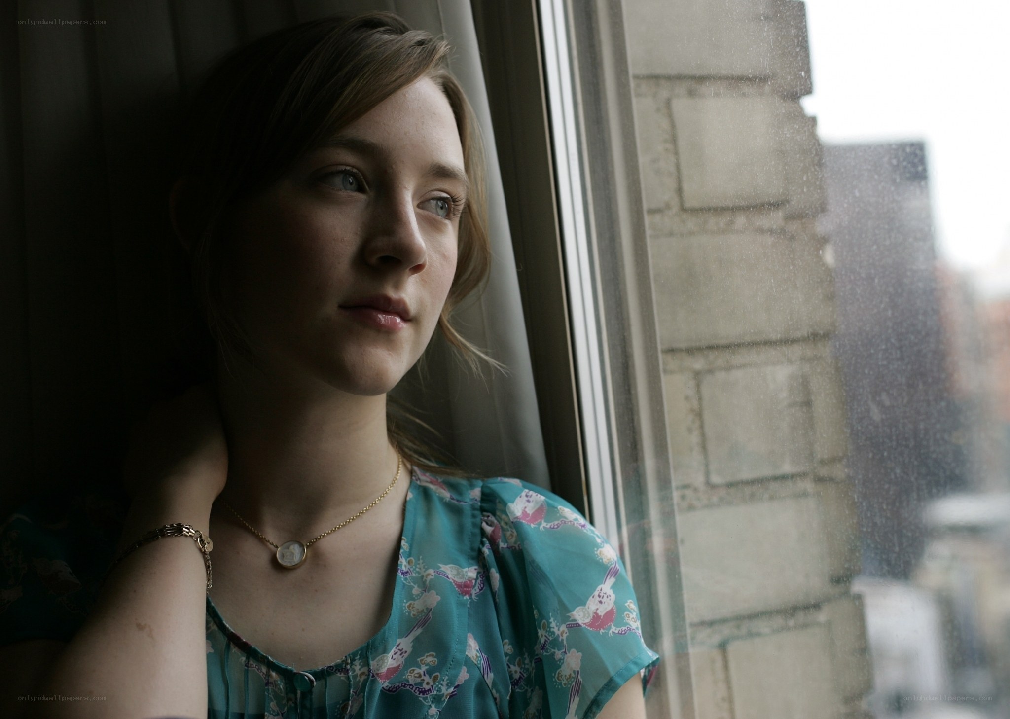 woman looking out window