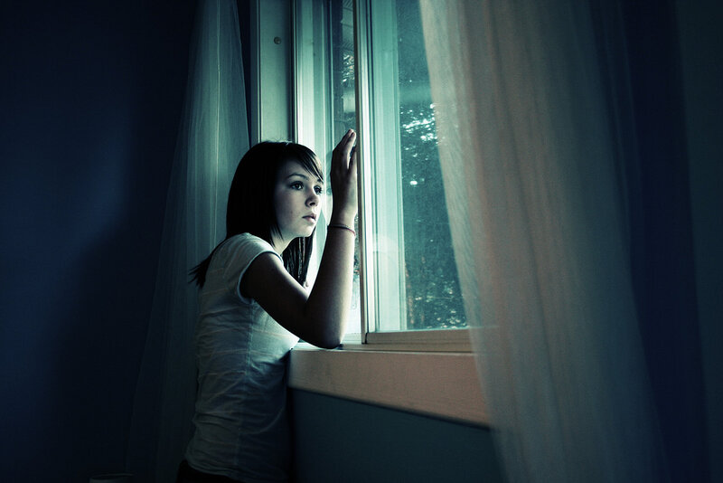 woman looking out window