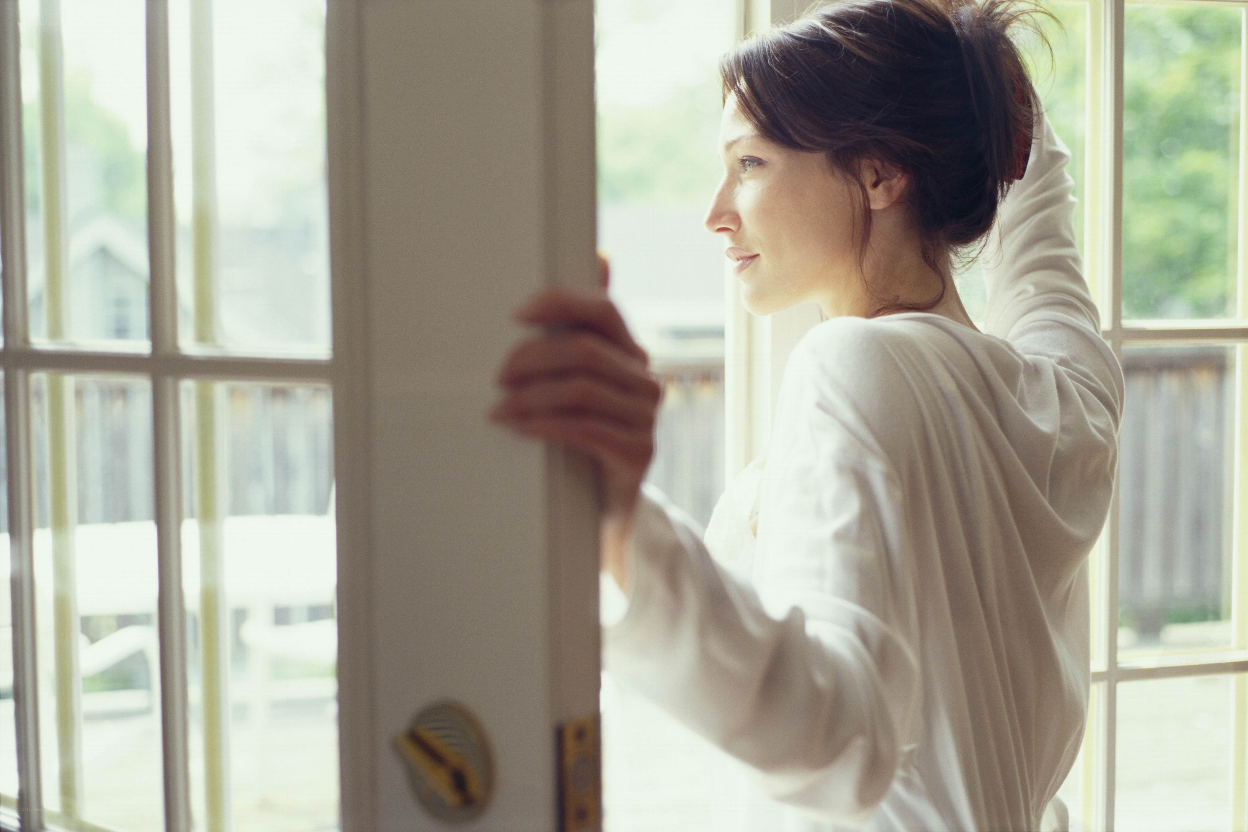 woman looking out window
