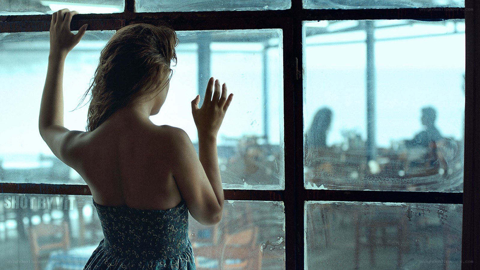 woman looking out window