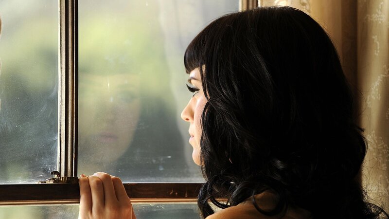 woman looking out window