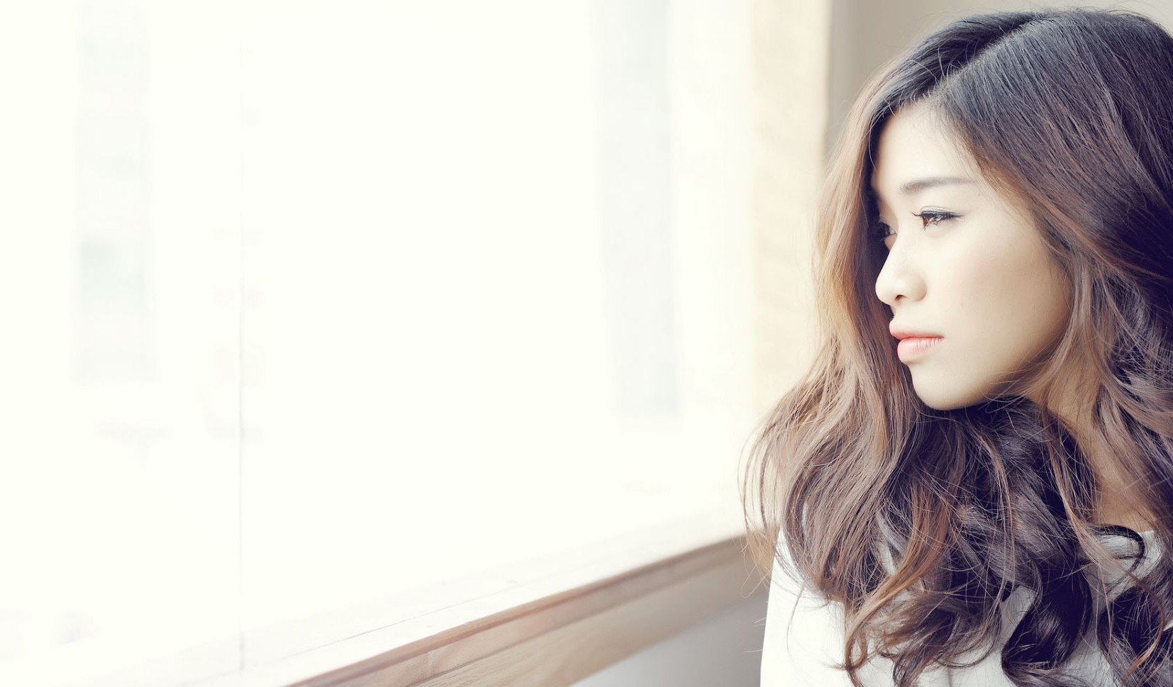 woman looking out window