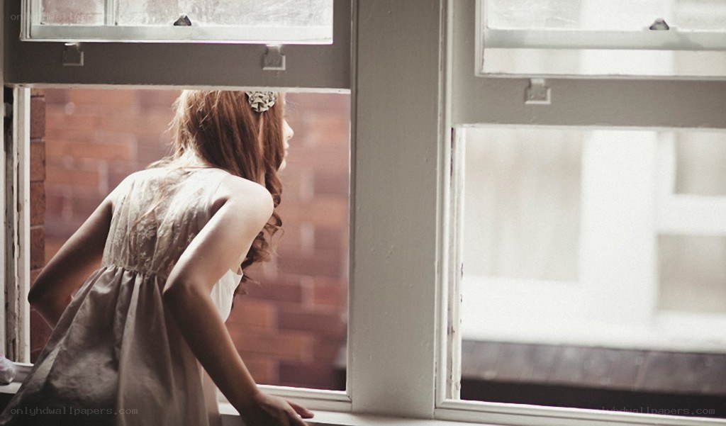 woman looking out window