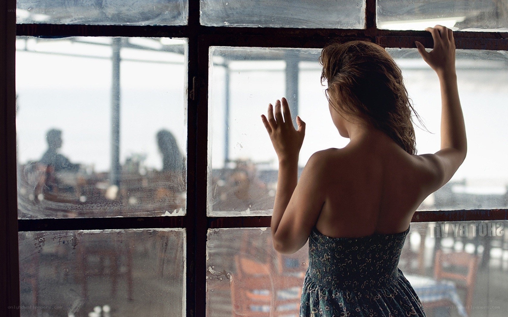woman looking out window