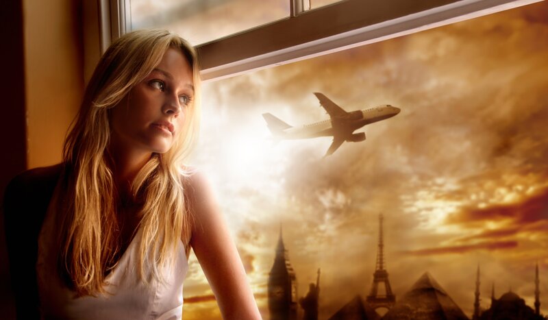 woman looking out window at airplane