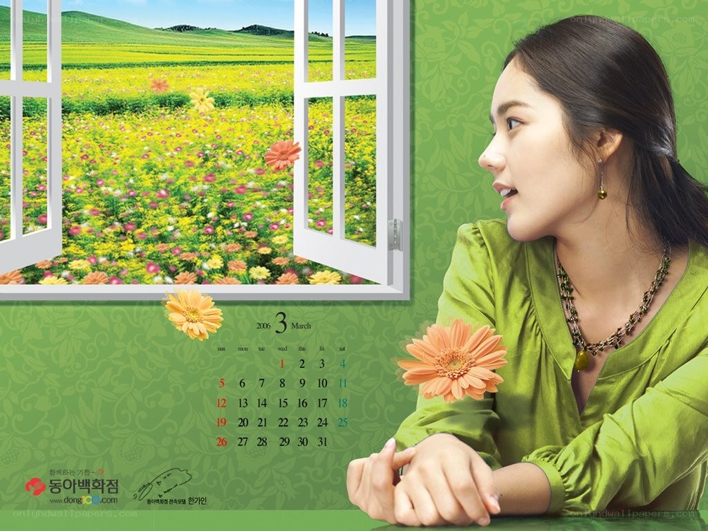 Woman looking out window at flowers