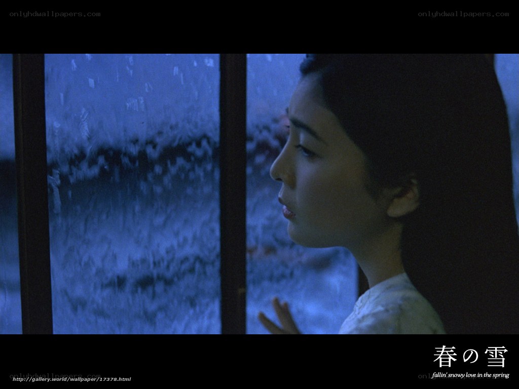 woman looking out window in blue light