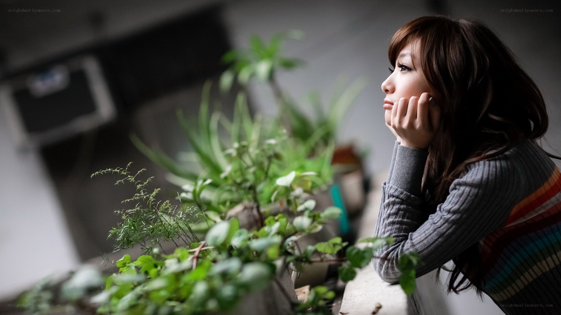woman looking out window thoughtfully