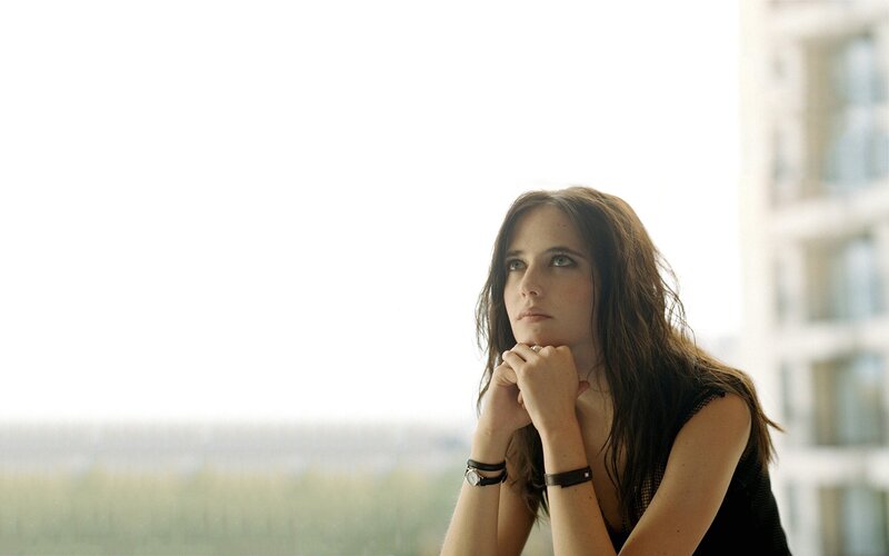 woman looking out window thoughtfully