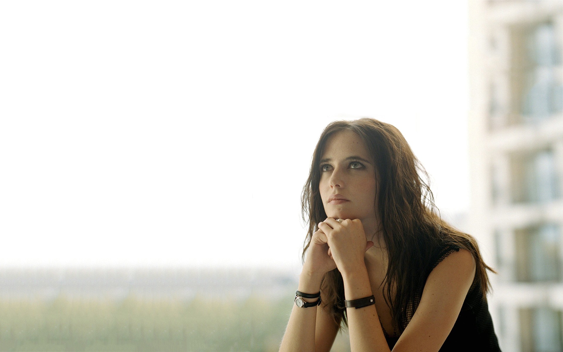 woman looking out window thoughtfully