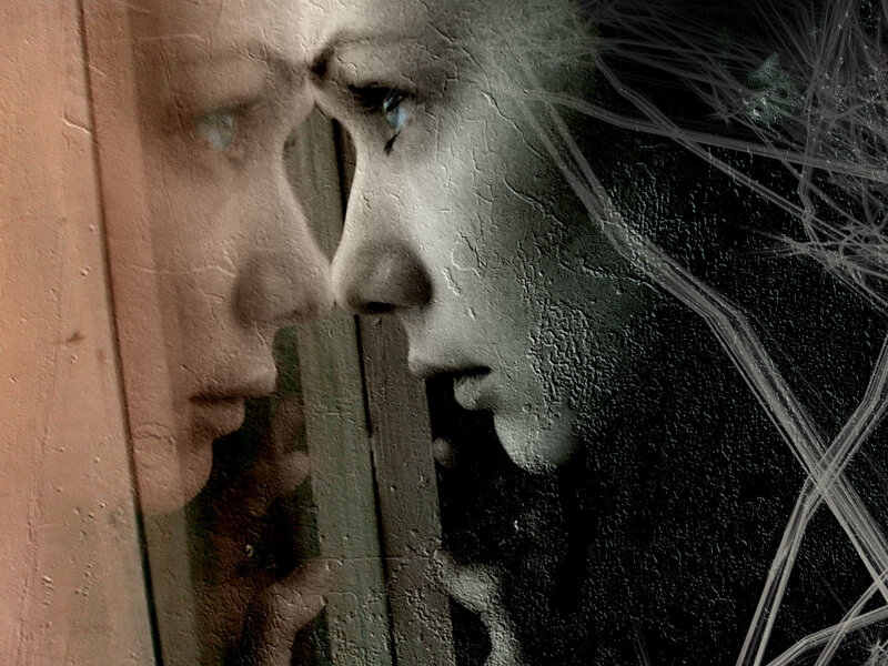 woman looking through cracked glass