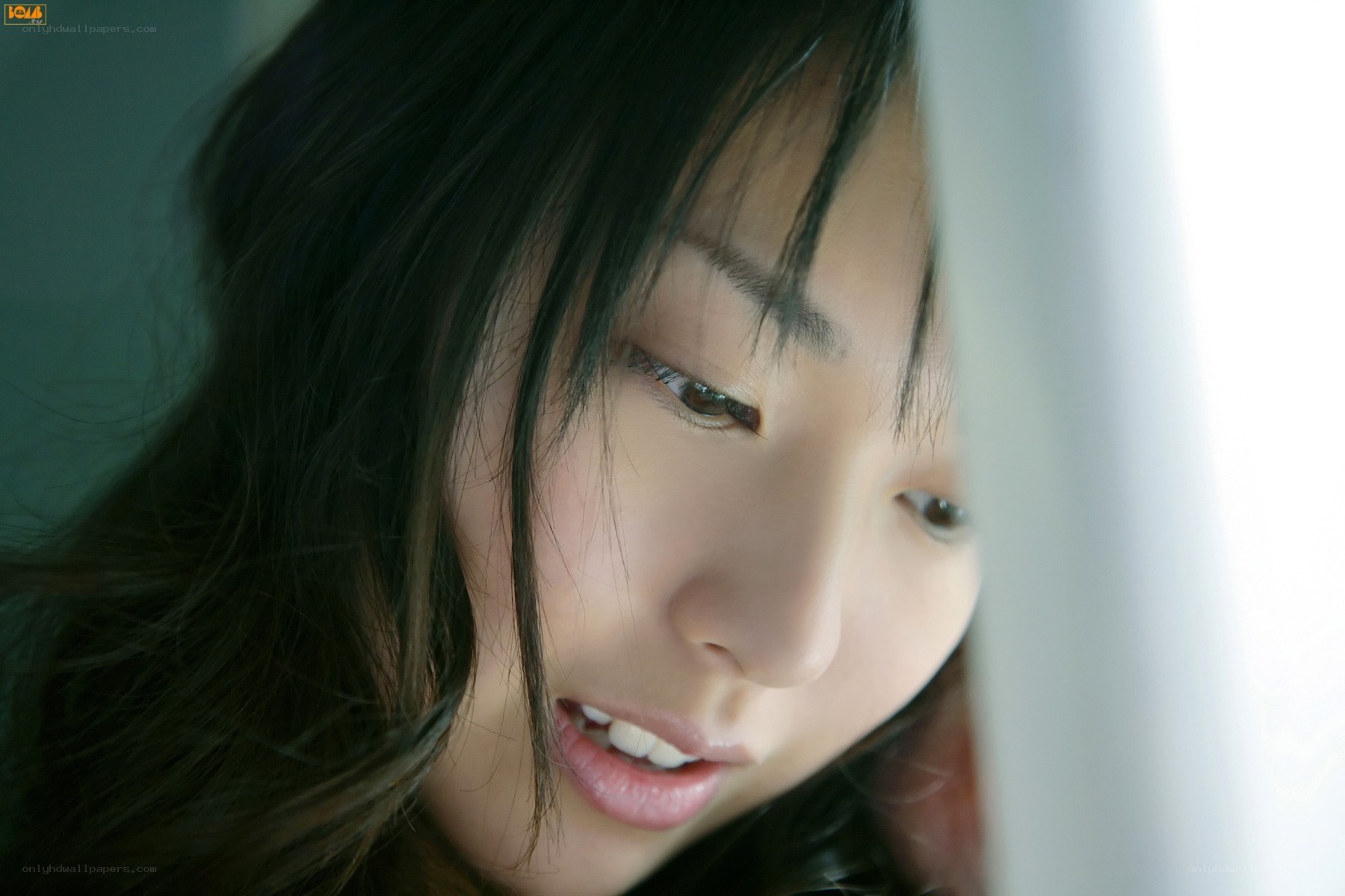 woman looking through curtain