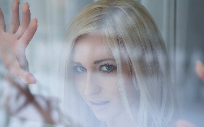 woman looking through glass