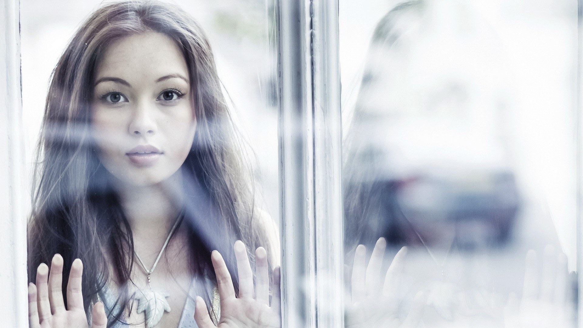 woman looking through glass window
