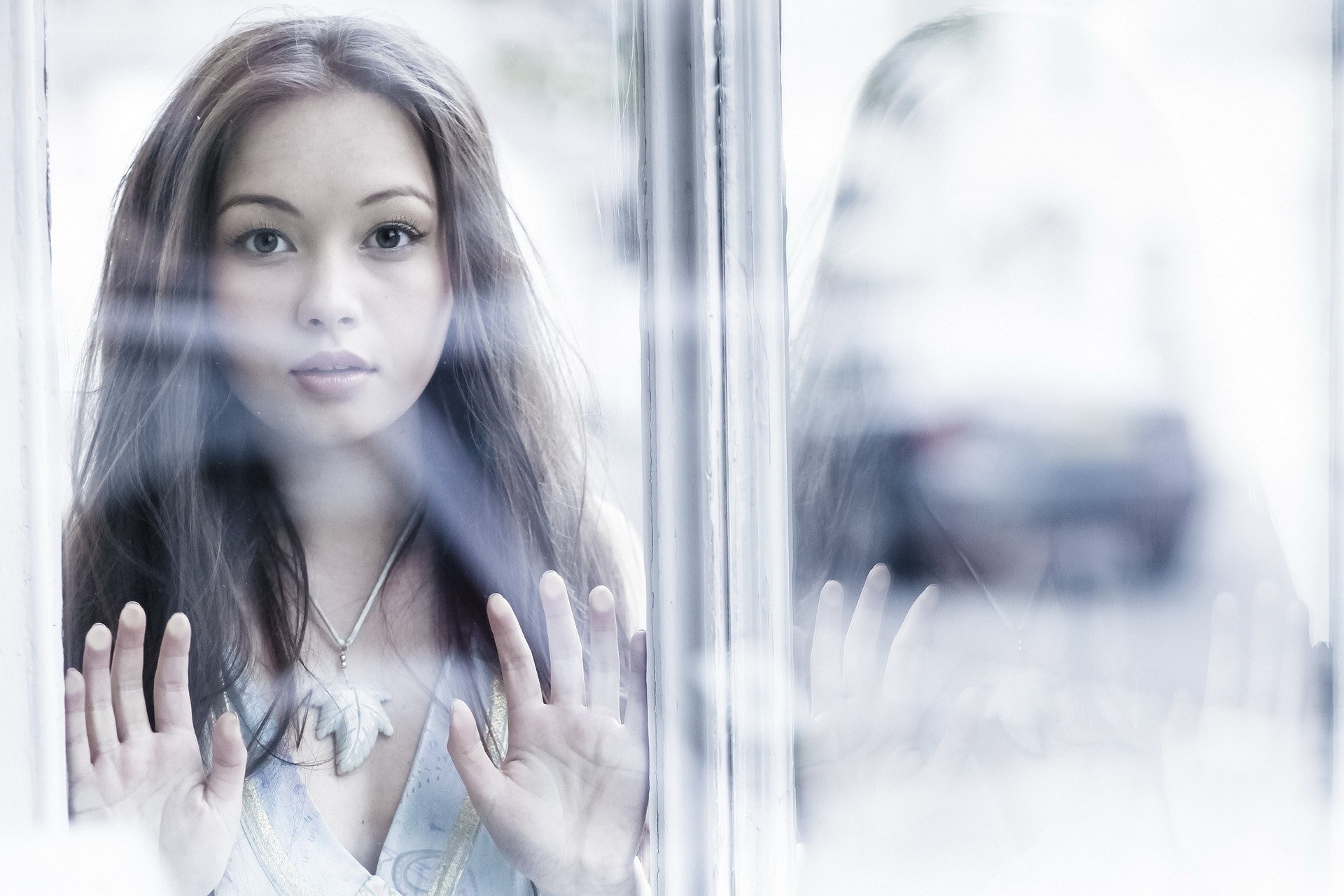 woman looking through window