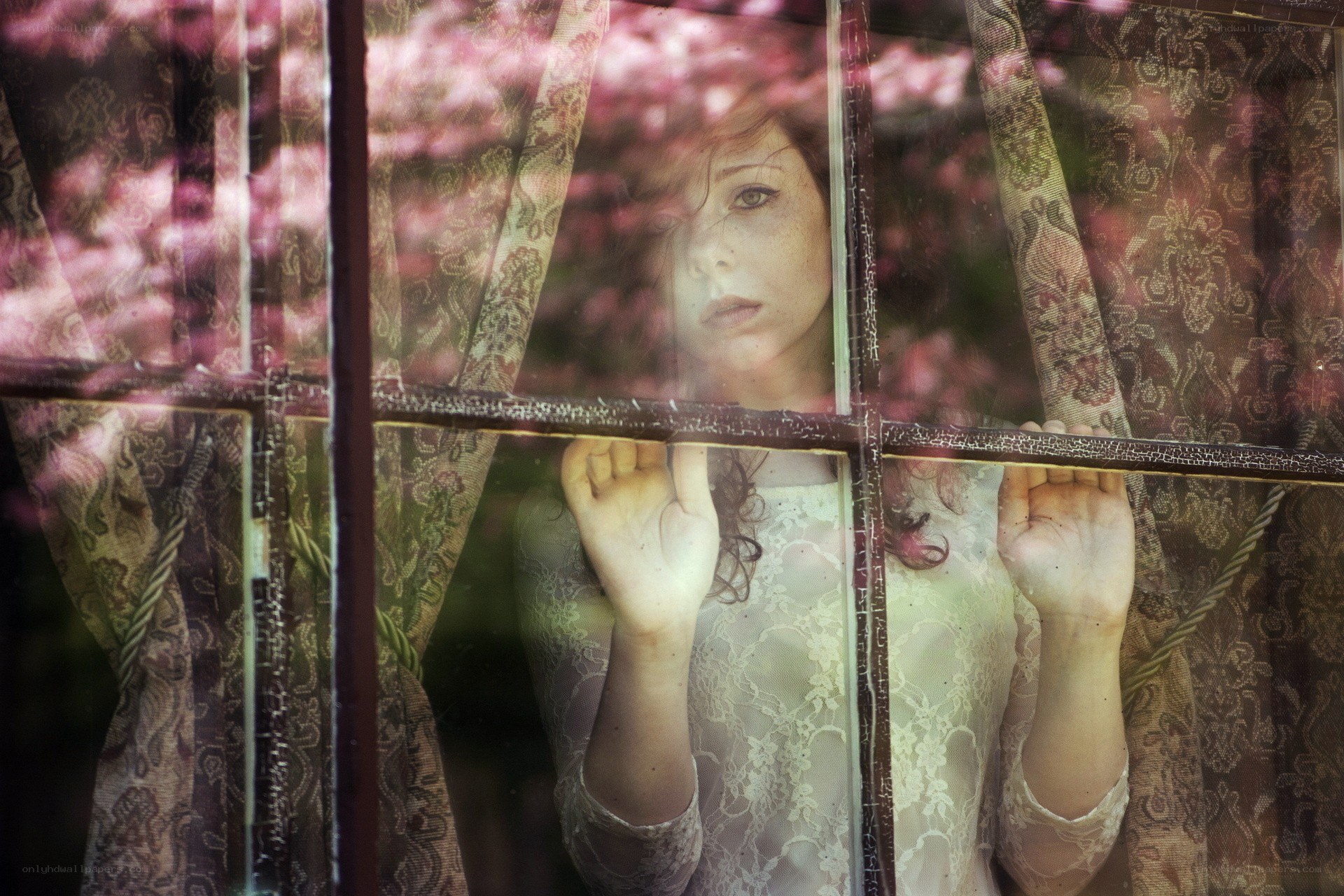 woman looking through window
