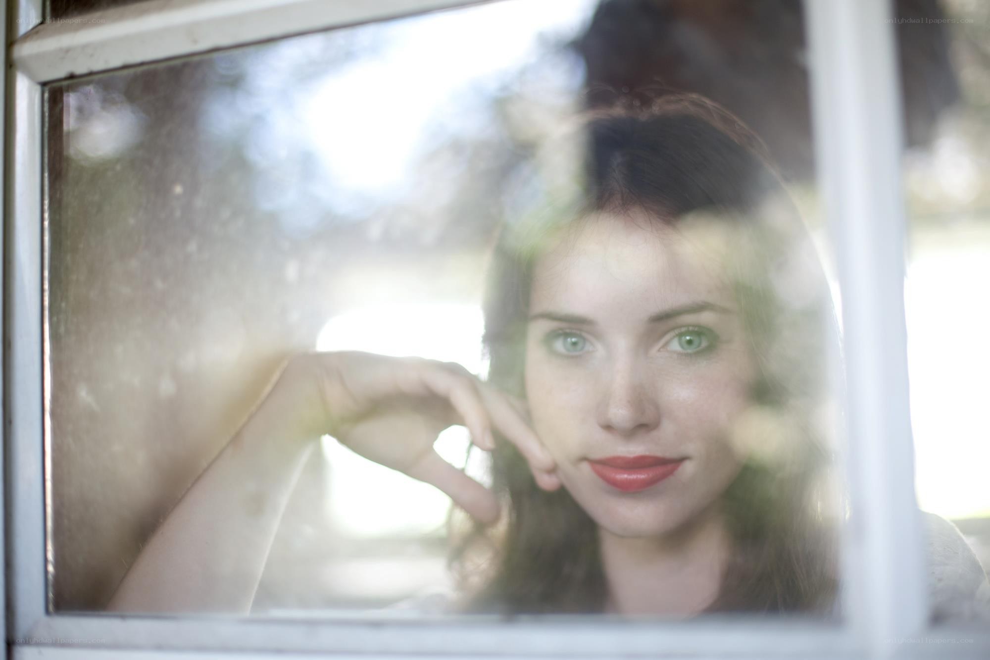 woman looking through window
