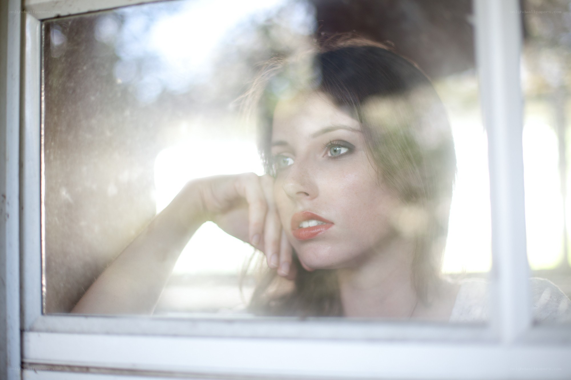 woman looking through window
