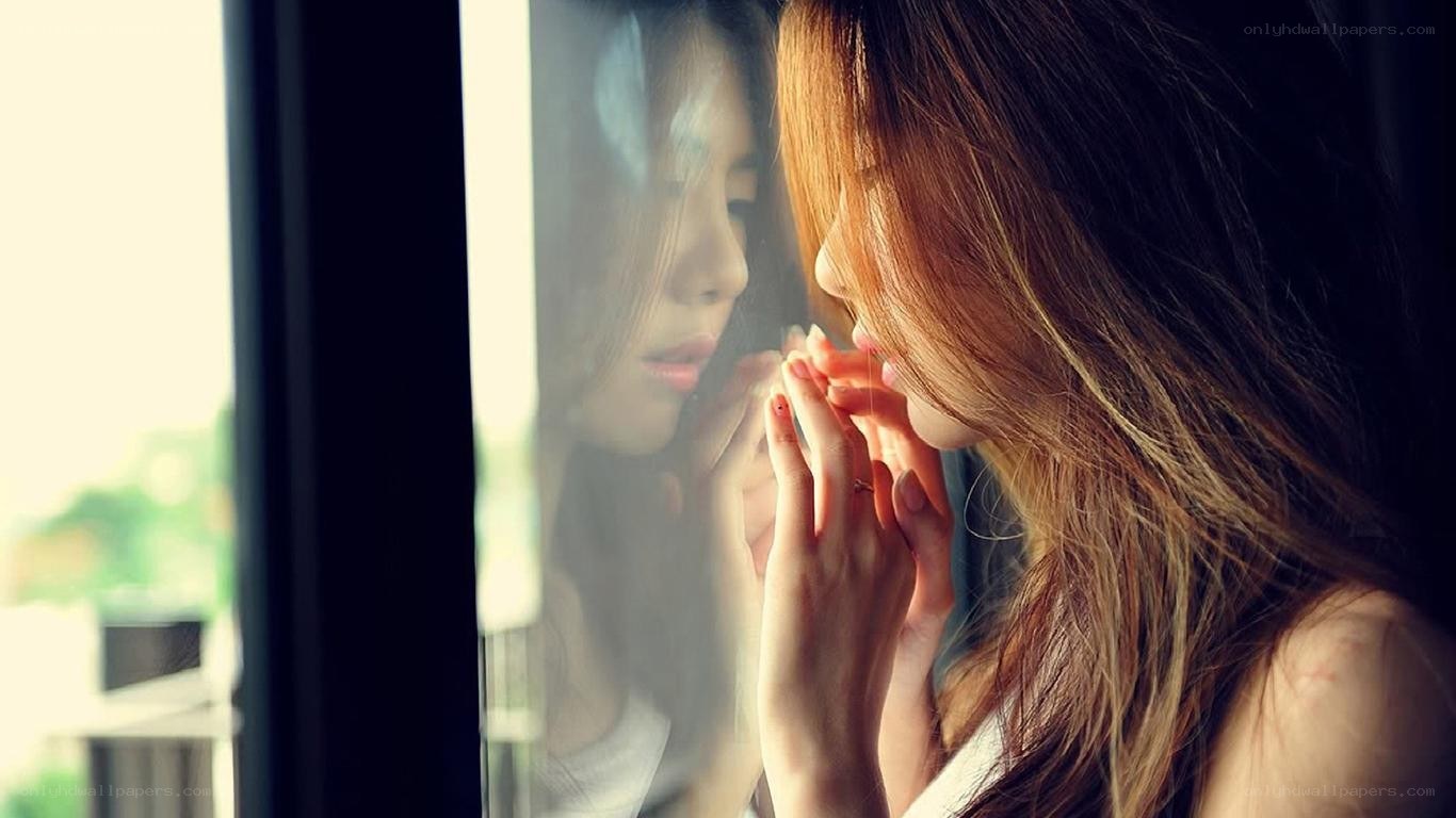 woman looking through window