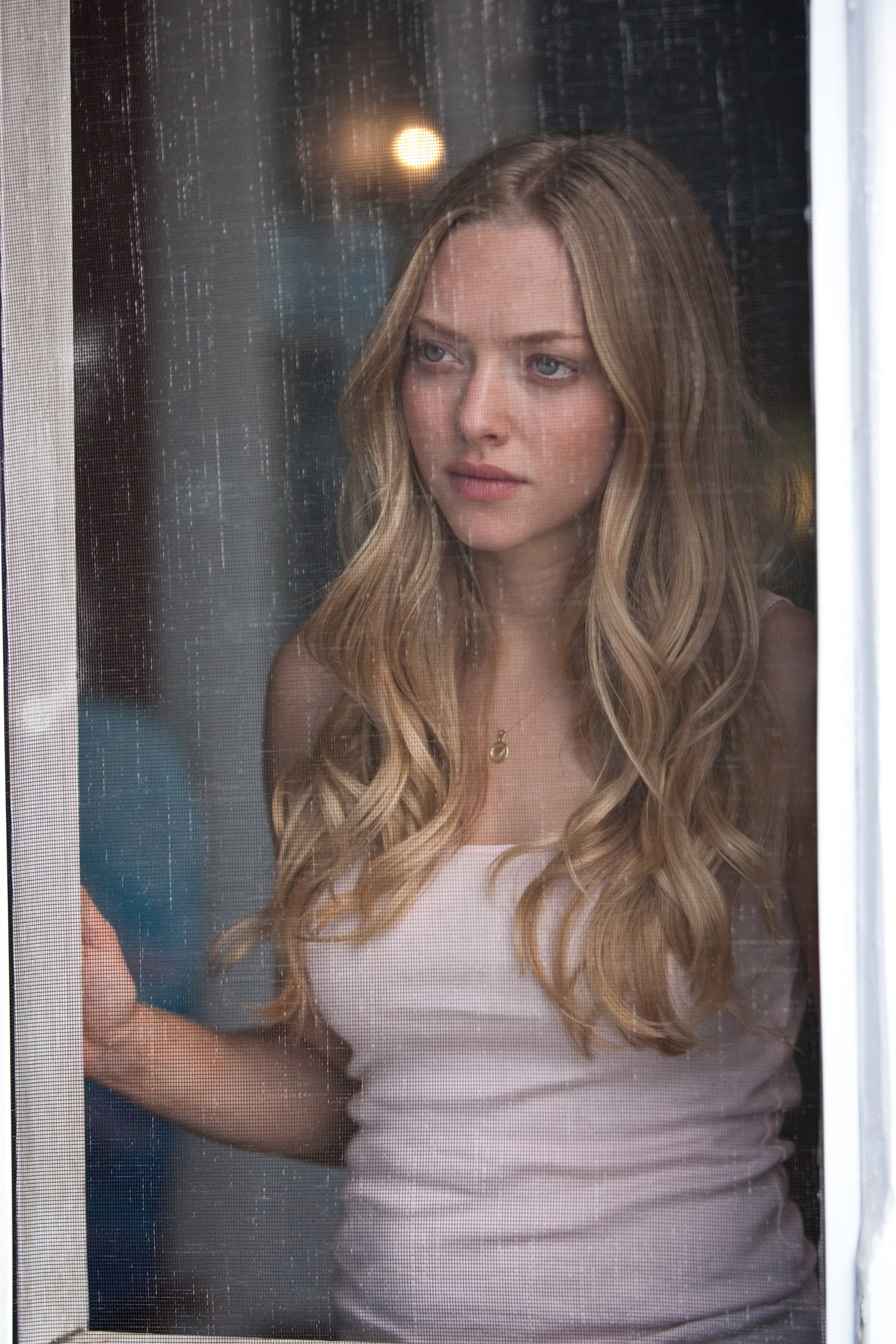 woman looking through window