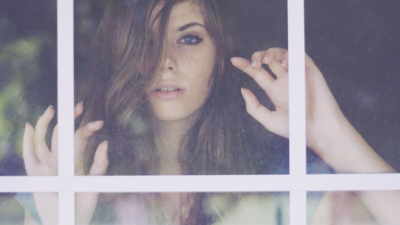 woman looking through window