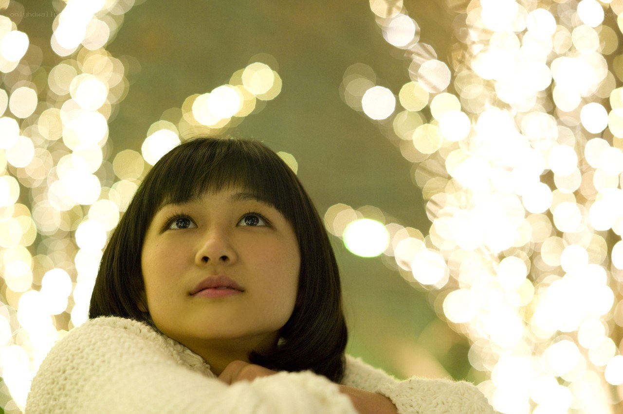 woman looking up at lights