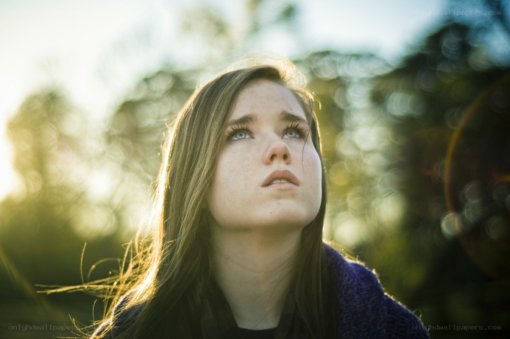 woman looking up at sunset