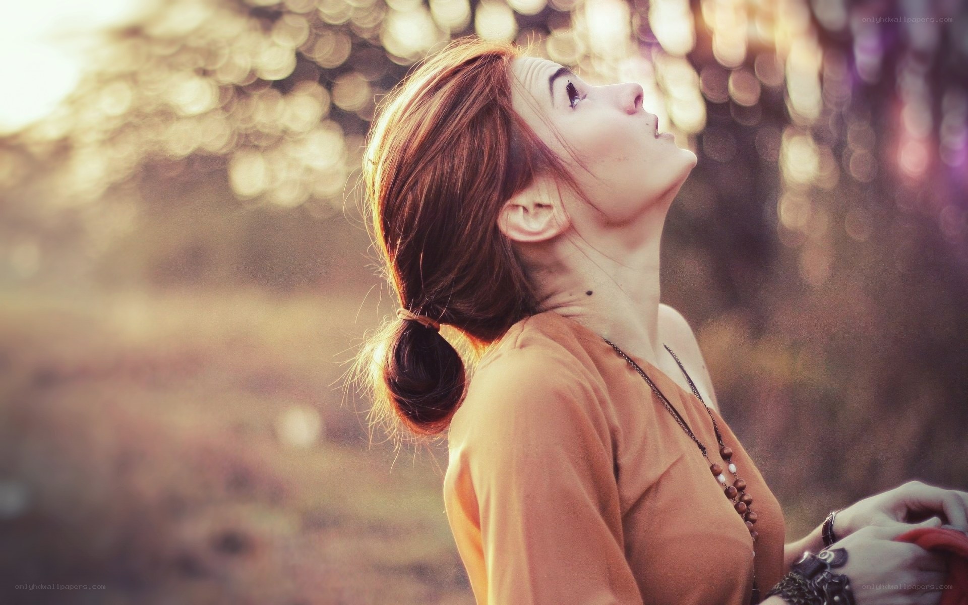 woman looking up at sunset