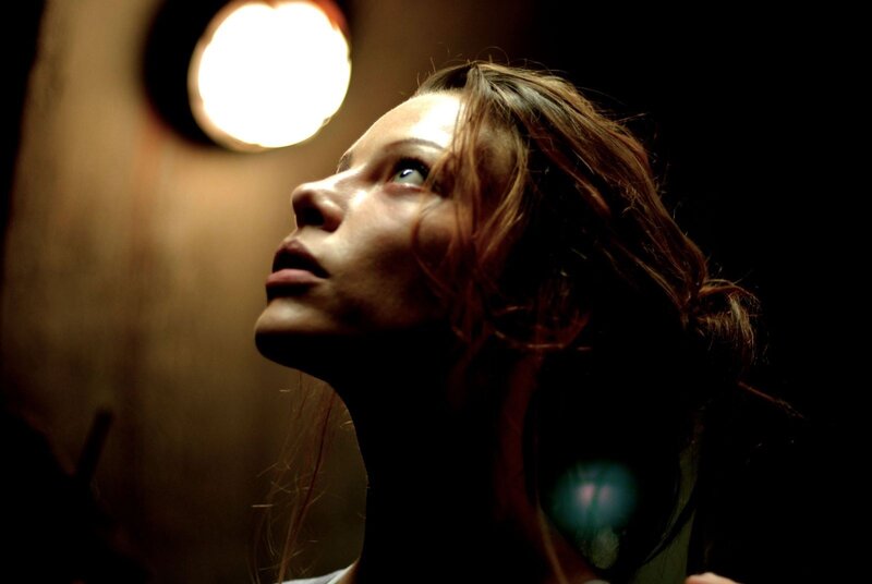 woman looking up in dim light