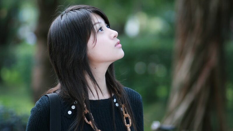 woman looking up in park
