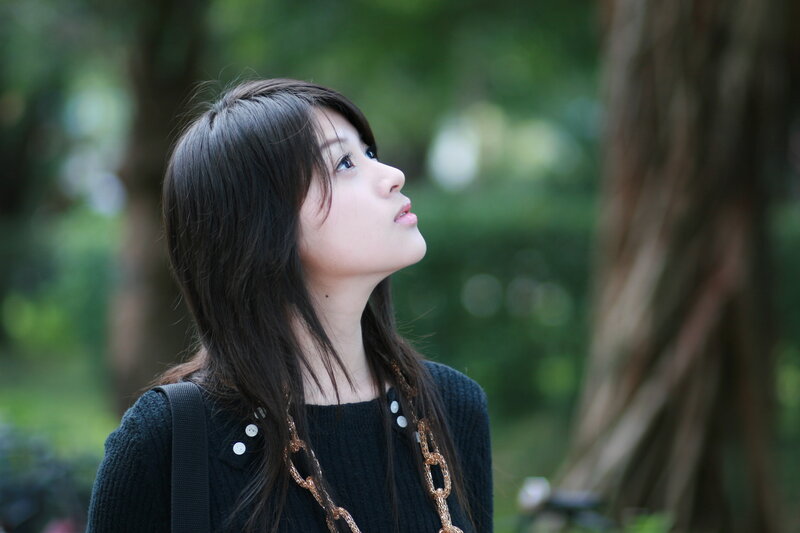 woman looking up in park