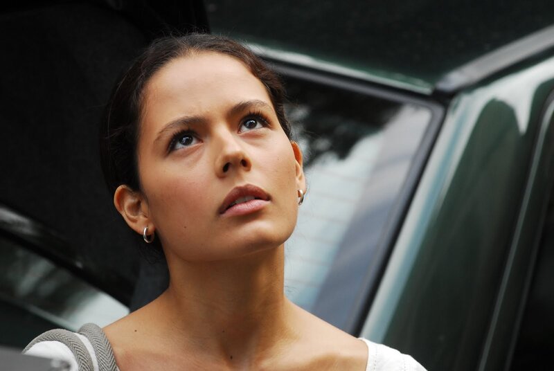 woman looking up near car