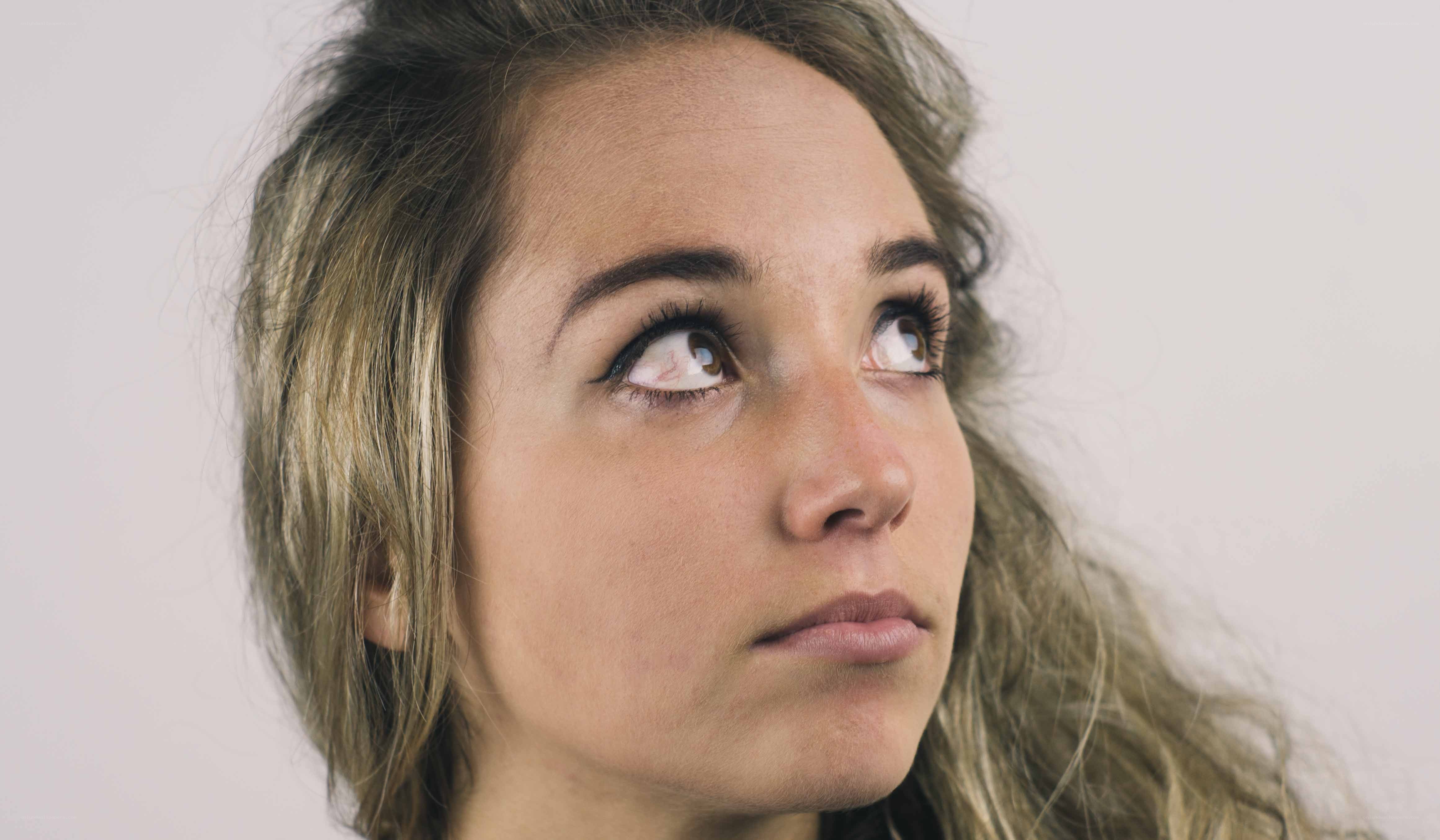 woman looking up thoughtfully