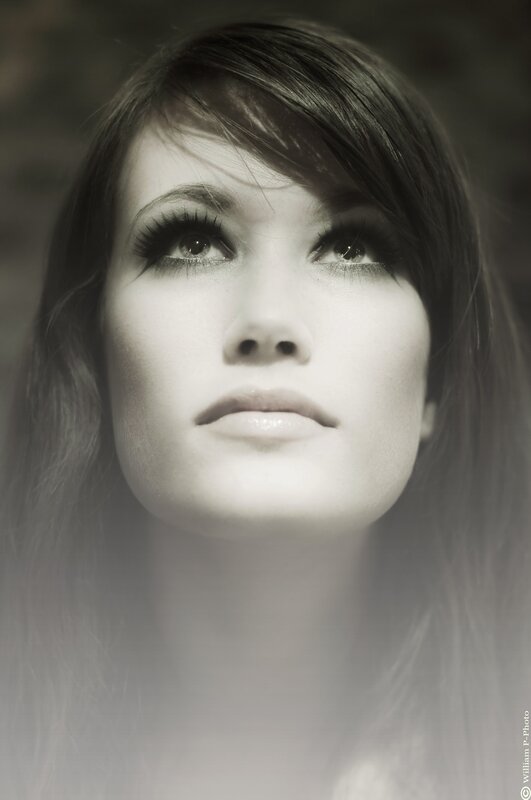 woman looking upward in black and white