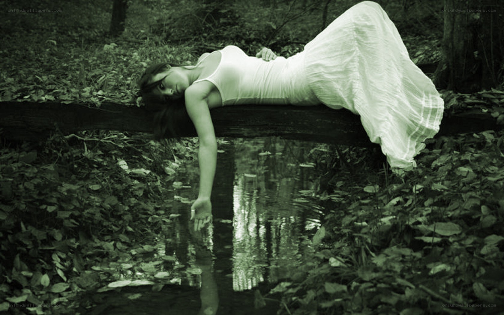 woman lying by a stream