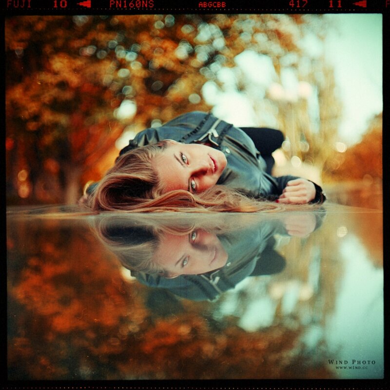 woman lying by water reflection