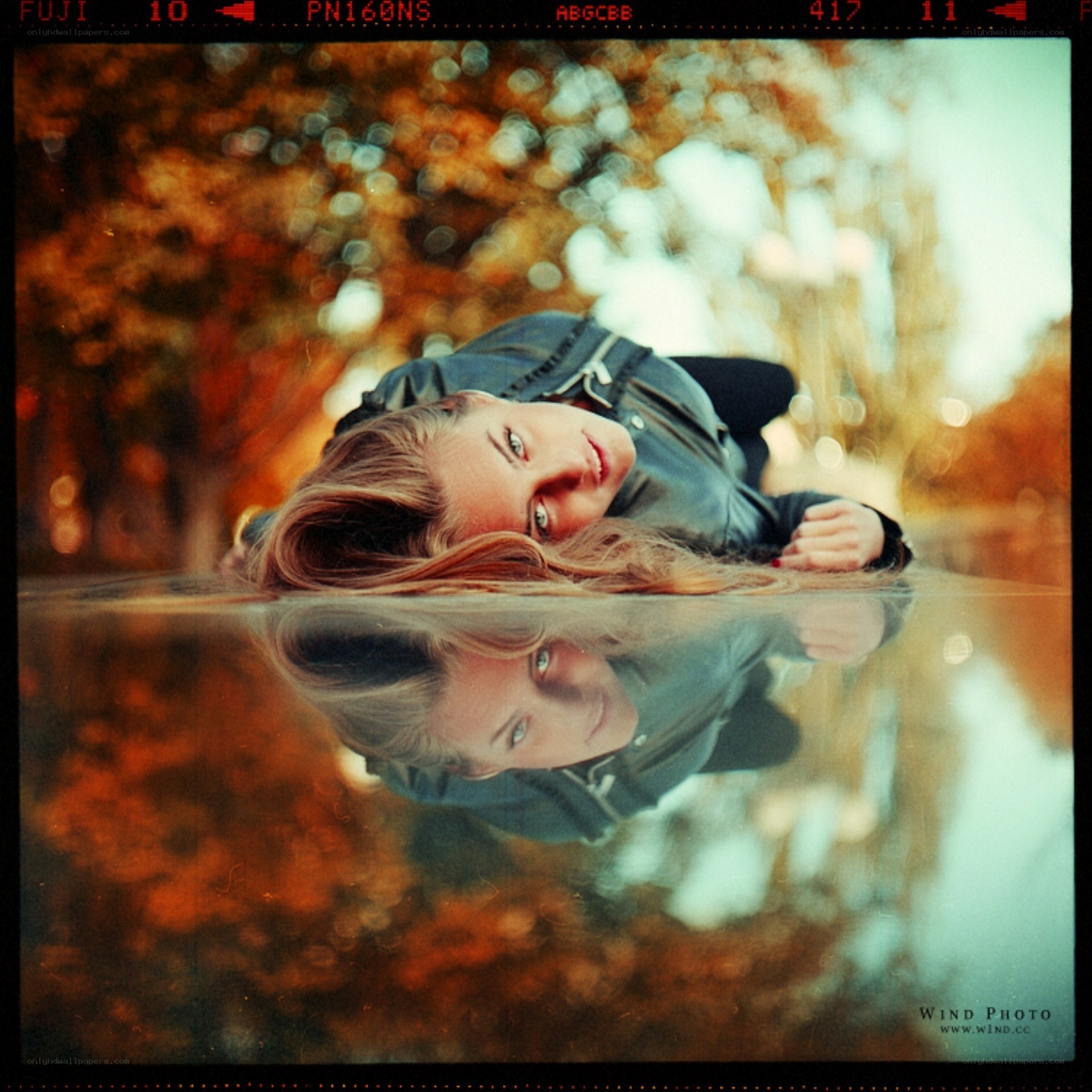 woman lying by water reflection
