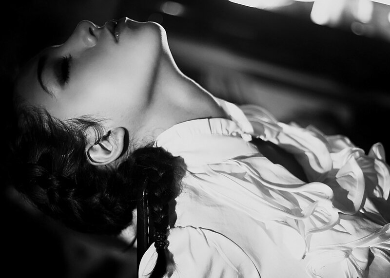 Woman Lying Down — Black, Dramatic, Photograph, Braided Hair