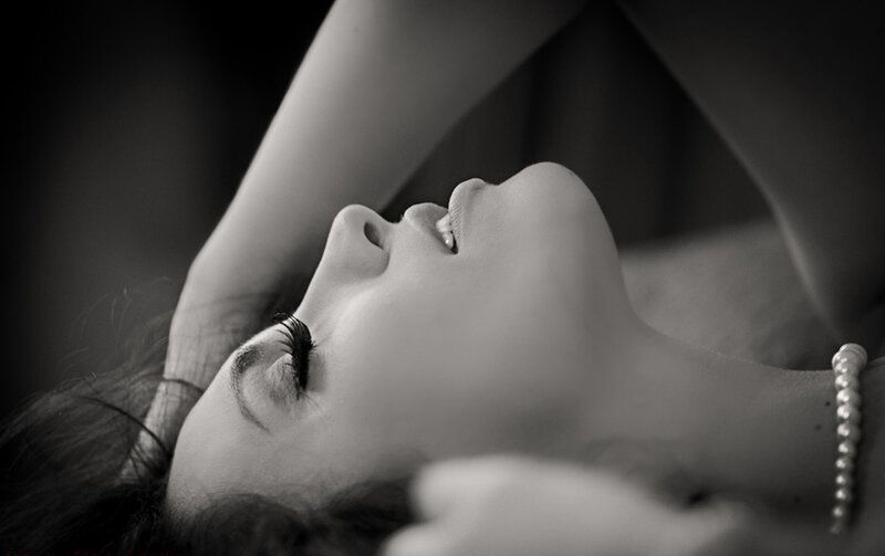 Woman Lying Down — Black, Dramatic, Photograph, Pearl Necklace, Long Eyelashes