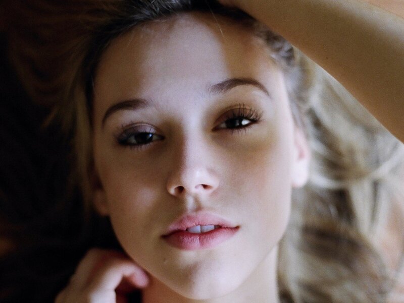 woman lying down looking at camera