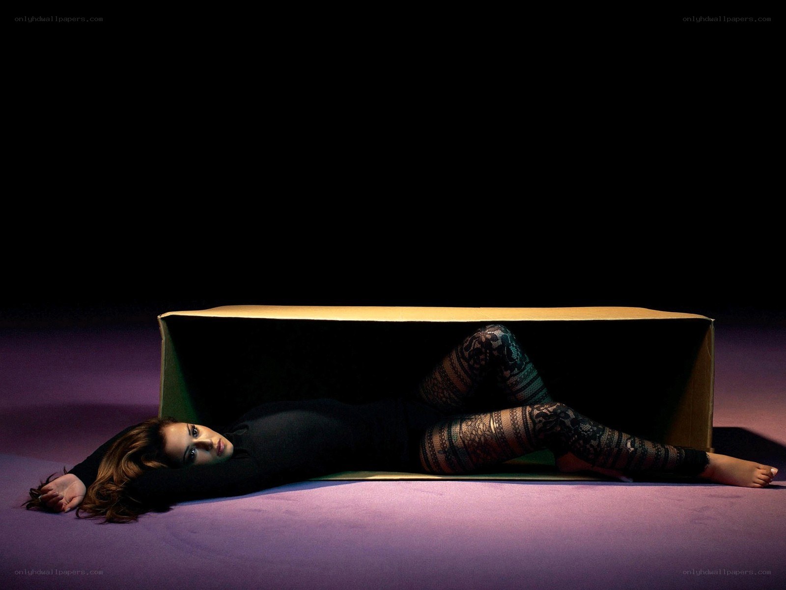 woman lying in a box