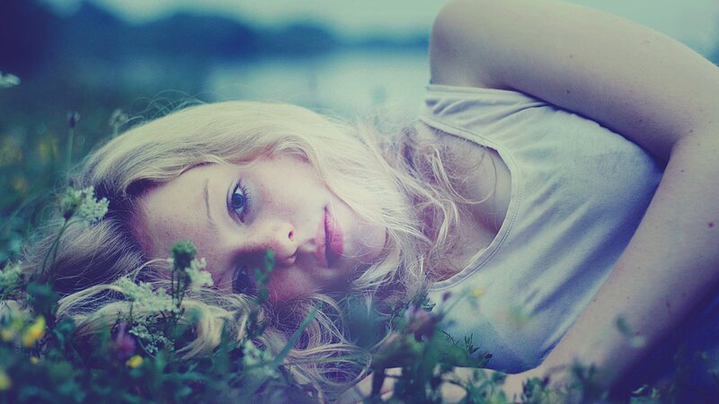 woman lying in a field of flowers