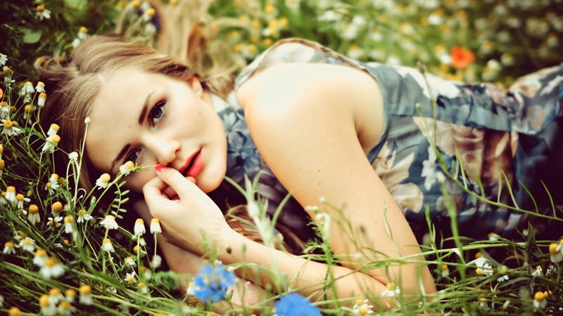 woman lying in a field of flowers