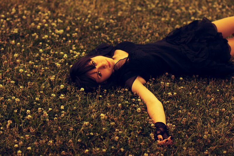 Woman lying in a field of flowers