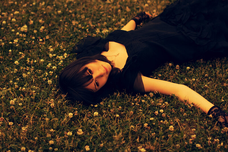 woman lying in a field of flowers