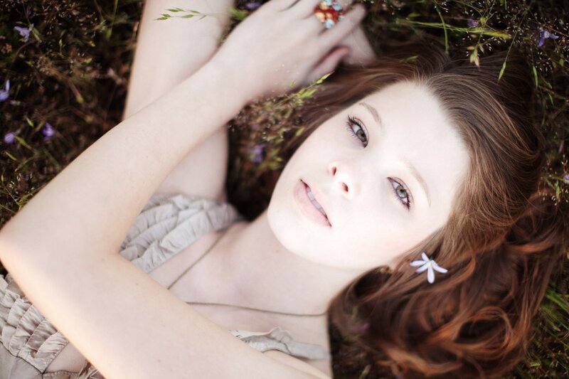 woman lying in a field of flowers